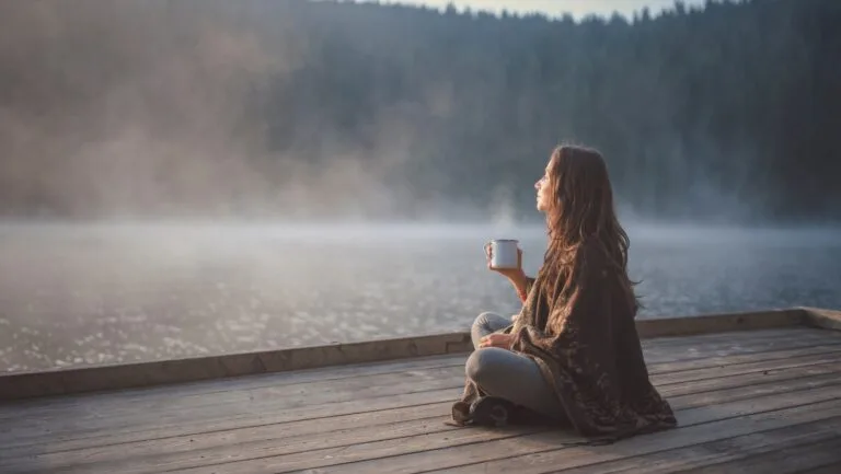 woman on dock with coffee 768x433 1